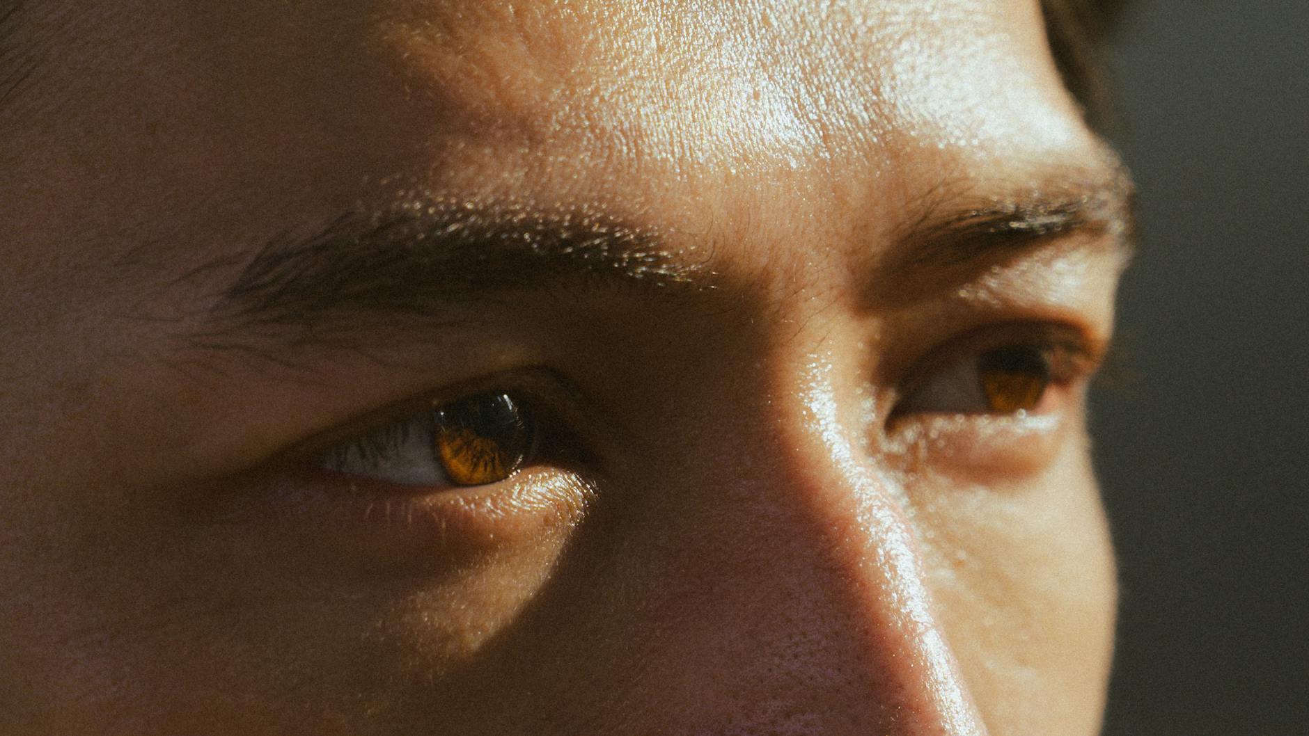 close up of human eyes with brown iris