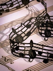 intricate black lace musical notes on sheet music