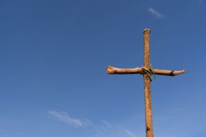 a wooden cross under the blue sky