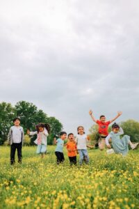 children on yellow flower field