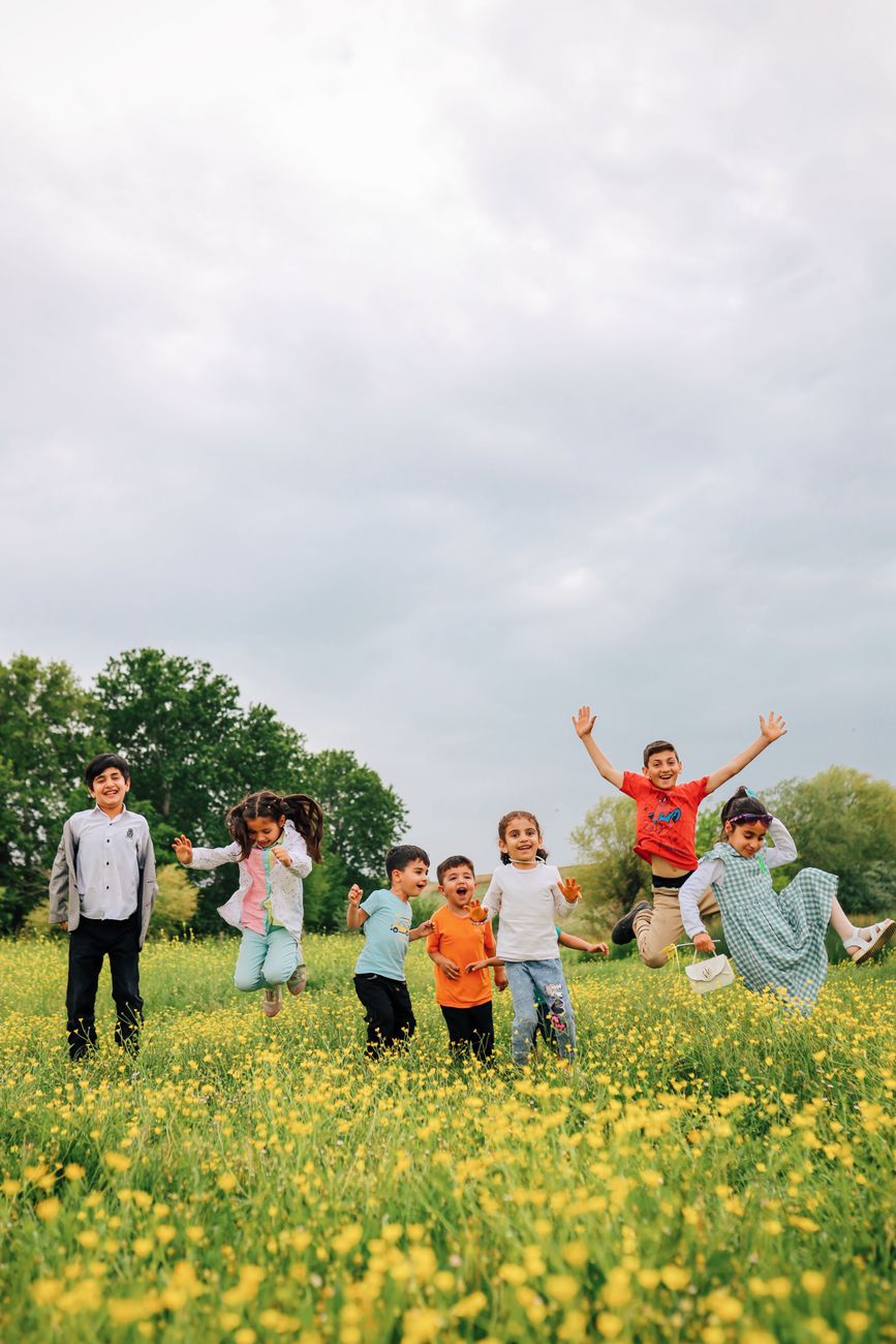 children on yellow flower field