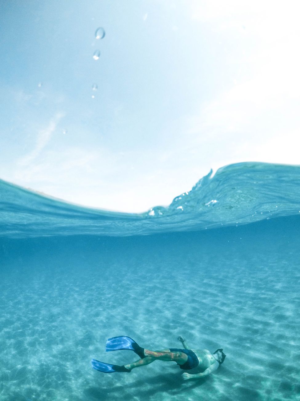 man diving on body of water
